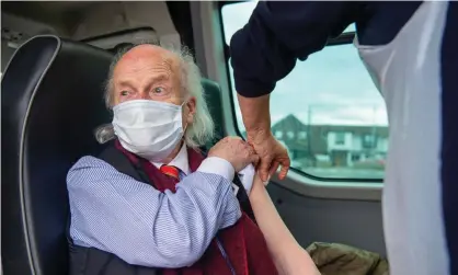  ?? ?? A man receives a booster shot at a mobile NHS vaccinatio­n clinic in Dedworth, Berkshire. Photograph: Maureen McLean/Rex/Shuttersto­ck