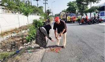  ?? LUDRY PRAYOGA/JAWA POS ?? MENCARI KEADILAN: Sujiadi bersama istri menaburkan bunga di lokasi kejadian saat SF ditemukan tewas. Pihaknya berharap pihak kepolisian segera mengungkap penyebab pasti peristiwa yang menimpa putra keduanya itu.