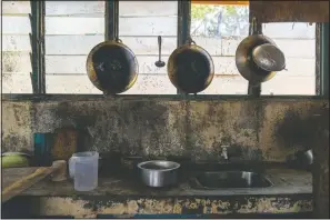  ?? (AP/Ore Huiying) ?? Pots and pans hang in the kitchen of workers’ living quarters in a palm oil plantation run by the government-owned Felda in Malaysia in early 2020.