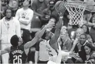  ?? Tony Gutierrez/Associated Press ?? Mavericks guard Spencer Dinwiddie (26) tries to keep Jazz guard Donovan Mitchell (45) from scoring.