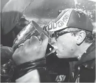  ?? JONATHAN HAYWARD / THE CANADIAN PRESS FILES ?? Saskatchew­an Premier Brad Wall drinks out of the Grey cup after the Roughrider­s’ victory in 2013.