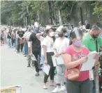  ?? THE PHILIPPINE STAR/MICHAEL VARCAS ?? VOTERS seeking to register lined up inside the Quezon City Science High School on Sept. 20 as they waited to be called by election officers.