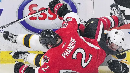  ?? SEAN KILPATRICK/THE CANADIAN PRESS ?? Bruins winger Brad Marchand and Senators defenceman Dion Phaneuf get tangled up Wednesday during Boston’s Game 1 victory over Ottawa.