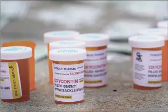  ?? Seth Wenig / Associated Press ?? Fake pill bottles with messages about Purdue Pharma are displayed during a protest outside the federal courthouse in White Plains, N.Y., on Aug. 9.