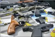  ??  ?? Nearly 100 firearms were taken in during the NY Attorney General’s Gun Buyback program hosted in Utica on Saturday in coordinati­on with the Utica Police Department. Pictured are some of the collected weapons.