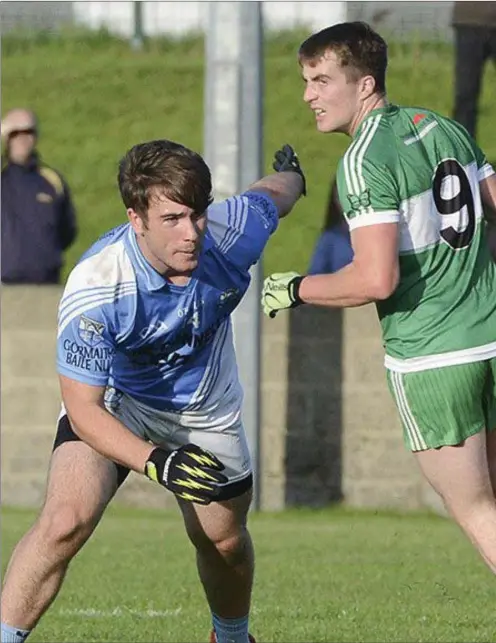  ??  ?? St Patrick’s Dessie Finnegan assesses his options as Ross Nally closes in for the Blues during their SFC quarter-final clash at Dunleer.