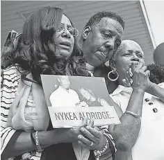  ?? ASHLEE REZIN, SUN- TIMES, VIA AP ?? Diann Aldridge holds a vigil for her daughter Nykea in Chicago.