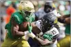  ?? MICHAEL CONROY — THE ASSOCIATED PRESS ?? Notre Dame running back Chris Tyree is tackled by California cornerback Lu-Magia Hearns III (15) during the first half Saturday in South Bend, Ind.