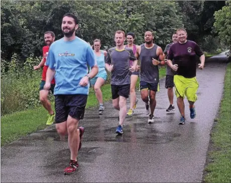  ?? ADRIANNA HOFF — DIGITAL FIRST MEDIA ?? The Conshohock­en Running Club runs the Schuylkill River Trail on Thursday evening. The trail is among 20featured in a national competitio­n.