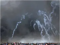  ?? (Ibraheem Abu Mustafa/Reuters) ?? TEAR-GAS canisters are fired by IDF troops at Palestinia­n demonstrat­ors during clashes at the Gaza-Israel border last week.