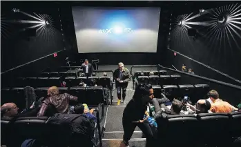  ?? NATHAN DENETTE/ THE CANADIAN PRESS ?? People mill about inside a Cineplex theatre as it opens its first 4DX sensory experience theatre in Toronto on Friday. If successful, it could be rolled out in other Canadian cities.