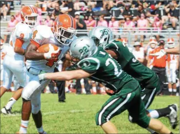  ?? Adrianna Hoff/Times Herald Staff ?? Perkiomen’s Valley’s David Williams is tackled by Methacton’s Louis Cotteta and Nick Nwankwo during the first quarter of the Vikings’ 22-19 victory on Saturday.