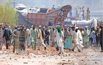  ?? Reuters ?? ■ Supporters of the banned Islamist political party Tehreek-e-Labaik Pakistan with sticks and stones block a road during a protest in Lahore yesterday.