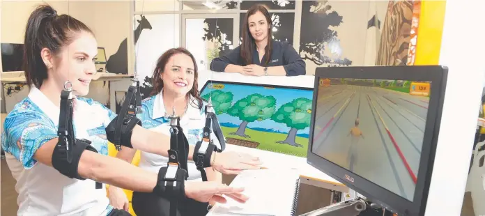  ??  ?? BREAKTHROU­GH TECHNOLOGY: Alliance Rehabilita­tion directors Anna Nicholls ( centre) and Andrea van Grinsven ( right) with occupation­al therapist Alana Skinner and some of the robotics equipment.