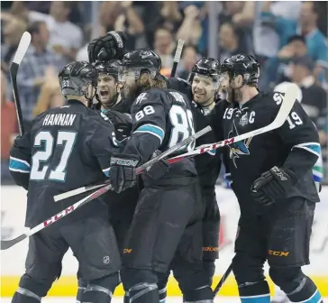  ?? Christian Petersen/getty Images ?? Scott Hanna, left, T.J. Galiardi, Brent Burns, Brad Stuart and Joe Thornton of the San Jose Sharks celebrate after Burns scored a first-period goal against the Vancouver Canucks in Game 4 of the Western Conference quarter-finals Tuesday night in San...