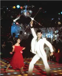  ?? PARAMOUNT PICTURES ?? LEFT: The white suit Travolta wore in “Saturday Night Fever” ( alongside Karen Lynn Gorney) belonged for a time to Chicago film critic Gene Siskel.