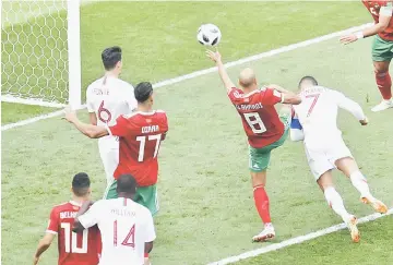  ?? — AFP photo ?? Portugal’s Cristiano Ronaldo heads the ball to score during the Russia 2018 World Cup Group B match against Morocco at the Luzhniki Stadium in Moscow.