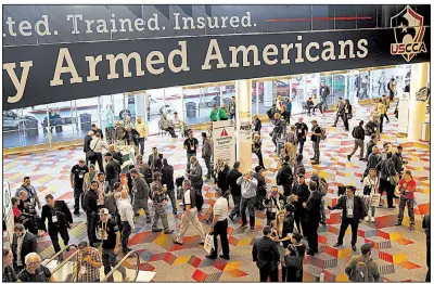  ?? AP/JOHN LOCHER ?? People attend the annual Shooting, Hunting and Outdoor Trade Show on Wednesday in Las Vegas. Arkansas Gov. Asa Hutchinson attended this year’s event.