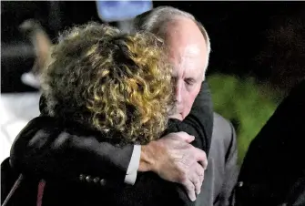  ?? DAVID T. FOSTER III/THE CHARLOTTE OBSERVER VIA AP ?? UNC Charlotte Chancellor Philip DuBois receives a hug Tuesday after a news conference regarding a deadly shooting on the campus earlier in the day in Charlotte, N.C.