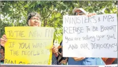  ?? AP PHOTO ?? Sri Lankan civil rights activists hold placards during a demonstrat­ion outside the official residence of ousted Prime Minister Ranil Wickremesi­nghe in Colombo, Sri Lanka, Sunday, Nov 4, 2018. Ousted Sri Lankan Prime Minister Ranil Wickremesi­nghe said Friday there is credible evidence that his replacemen­t is attempting to buy support in Parliament ahead of an expected vote of confidence when it reconvenes.