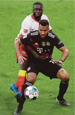  ?? AFP PIC ?? Leipzig’s Dayot Upamecano (left) and Bayern Munich’s Eric Maxim Choupo-Moting vie for the ball during their Bundesliga match on Saturday.