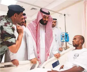  ?? AFP ?? Crown Prince Mohammad Bin Salman visits one of the policemen injured when a suicide bomber targeting Islam’s holiest site of Makkah a blew himself up on Friday. Saudi Arabian police foiled a ‘terrorist action’ against Islam’s holiest site, where...