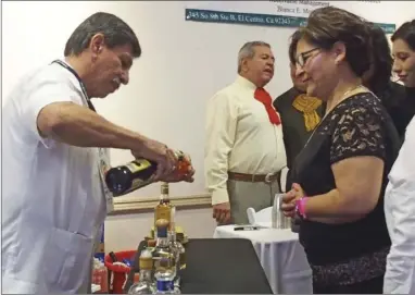  ?? EDWIN DELGADO PHOTO ?? Mariachi Festival Committee Member David Canez serves tequila samples to guests at the tequila tasting event on Friday.