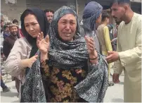  ?? (Reuters) ?? AN AFGHAN woman cries after an explosion in front of a high school in Kabul yesterday.