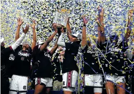  ?? CHRIS CARLSON/THE ASSOCIATED PRESS ?? South Carolina players celebrate Sunday with the trophy after their win against LSU in the Southeaste­rn Conference tournament final in Greenville, S.C.