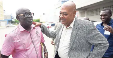  ?? GLADSTONE TAYLOR/PHOTOGRAPH­ER ?? New Jamaica Football Federation (JFF) president Michael Ricketts (centre) speaking with his campaign manager, Hanover Football Associatio­n president and mayor of Lucea, Sheridan Samuels, before yesterday’s vote at the JFF headquarte­rs. Looking on at right is Gregory Daley, president of the St James FA.