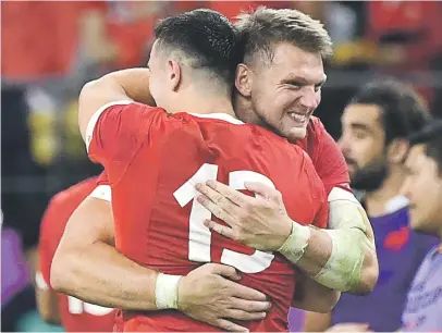  ?? Picture: AFP ?? RED-LETTER DAY. Welsh flyhalf Dan Biggar (right) hugs team-mate Owen Watkin after beating France in the quarterfin­als of the Rugby World Cup at the Oita Stadium yesterday.