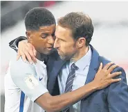  ??  ?? England manager Gareth Southgate, right, hugs Marcus Rashford during a World Cup qualifier.