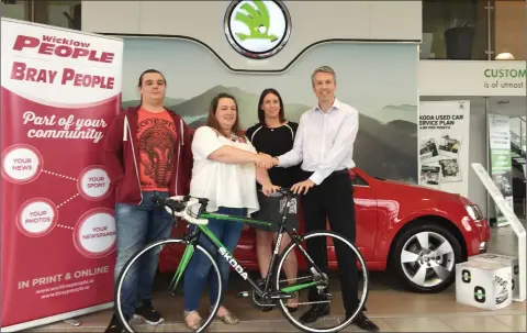  ??  ?? Mary Coleman from Bray and her son Ben (left) are presented with their bikes by Donna Murphy from the Wicklow People and Bray People and Stephen Healy, General Manager at Sinnott Autos last Friday.