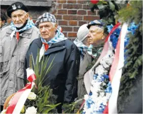  ?? THE ASSOCIATED PRESS ?? Auschwitz survivors remember those killed by Nazi Germany at the execution wall at the former Auschwitz death camp on Internatio­nal Holocaust Remembranc­e Day on Saturday in Oswiecim, Poland.