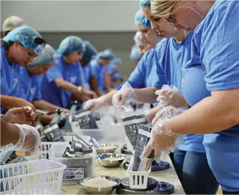  ?? (Special to The Commercial) ?? Volunteers put together 30,000 meal kits to feed the hungry during a campaign. The effort was sponsored by the Blue & You Foundation and facilitate­d by the United Way of Southeast Arkansas. The United Way and the Arkansas Community Foundation are urging residents to donate to their favorite charity today, which is Giving Tuesday.