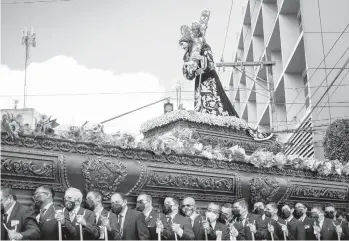  ?? JOHAN ORDONEZ/GETTY-AFP ?? Holy Week procession: An image of Jesus is carried by Catholic faithful as they take part in La Resena procession Tuesday during Holy Week in Guatemala City. The procession began early in the morning with parishione­rs carrying a multitude of religious images and statues or bouquets of flowers. Good Friday and Easter are in a few days.