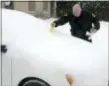  ?? ASSOCIATED PRESS ?? Hazleton Patrolman Walt Mazur places a ticket on the snow covered windshield of a vehicle whose driver violated the snow emergency parking ban and parked on the wrong side of North Wyoming Street in Hazleton Wednesday. A spring nor’easter targeted the...