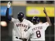  ?? TONY GUTIERREZ — THE ASSOCIATED PRESS ?? The Houston Astros' Yordan Alvarez greets third base coach Gary Pettis after hitting a home run Saturday.