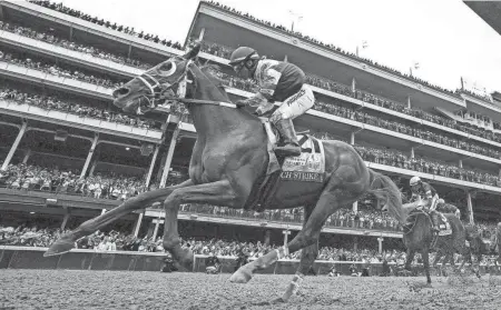  ?? MICHAEL CLEVENGER AND O’NEIL ARNOLD/LOUISVILLE COURIER-JOURNAL ?? Rich Strike, with Sonny Leon aboard, runs to victory in the 148th running of the Kentucky Derby on May 7 at Churchill Downs.