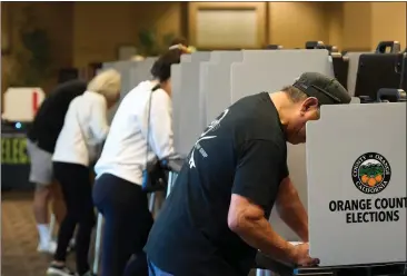  ?? LAUREN JUSTICE — FOR CALMATTERS ?? Voters fill out their ballots at a vote center at the Huntington Beach Central Library in Huntington Beach on March 5.