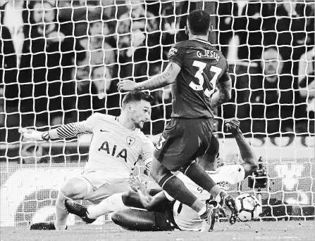  ?? FRANK AUGSTEIN THE ASSOCIATED PRESS ?? Manchester City’s Gabriel Jesus scores during an English Premier League soccer match against Tottenham Hotspur at Wembley Stadium in London on Saturday. Man City won the contest, 3-1.