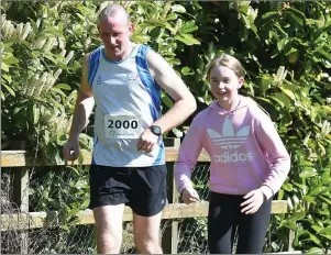  ??  ?? Ollie McHugh is joined for a few laps by his daughter sarah in his garden in Tinure