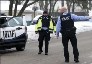  ?? (AP/Chicago Tribune/ Antonio Perez) ?? Joliet police officers work at the scene where multiple people were shot to death on Tuesday.