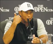  ?? Matt Dunham / Associated Press ?? Tiger Woods, shown at a news conference in July before the British Open, responded to the protests and some of the violence around the country by saying points can be made without destroying property.