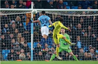  ?? AP ?? Gabriel Jesus scores a goal against Burton’s Johmn Brayford and goalkeeper Bradley Collins during the League Cup semifinal first leg. —