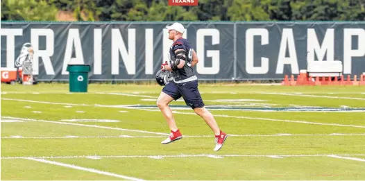  ?? Brett Coomer photos / Houston Chronicle ?? It’s back to work for defensive star J.J. Watt as he trots onto the field for the first day of camp Wednesday in White Sulphur Springs, W.Va.
