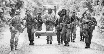  ??  ?? File photo shows Australian Army soldiers Major General Stuart Smith (left) and Sergeant Francis Jakis (centre) run with Indonesian Army soldiers during the Junior Officer Combat Instructor Training course conducted by the Australian Army’s Combat...