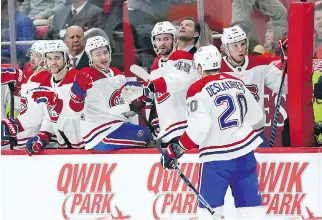  ?? CARLOS OSORIO/THE ASSOCIATED PRESS ?? Canadiens winger Nicolas Deslaurier­s is congratula­ted by teammates after the first of his two goals Thursday night in Detroit.