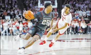  ?? Garett Fisbeck The Associated Press ?? Oklahoma guard Grant Sherfield drives against Alabama guard Rylan Griffen in the Sooners’ 93-69 victory Saturday at the Lloyd Noble Center. Sherfield had 30 points.