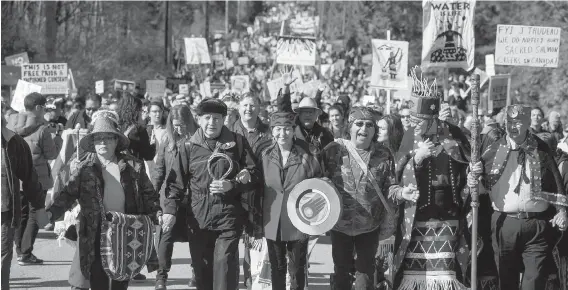  ??  ?? Indigenous chiefs and elders lead thousands of people in a march against the Kinder Morgan Trans Mountain pipeline expansion, in Burnaby on Saturday.